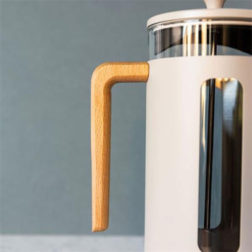 Close-up shot of a cream cafetiere on a grey background.